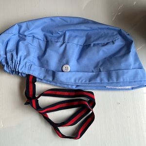Women’s blue scrub cap with bun space and buttons for mask